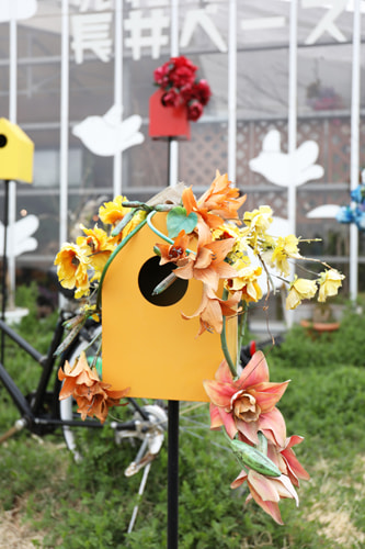 オレンジの巣箱と花のオブジェ